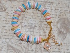 Handgjort sommararmband med färgglada snäckbitar, emaljerad blomcharm och vit sötvattenspärla. Justerbart med 3 cm förlängningsk