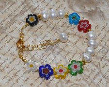 Färgstarkt Y2K-armband med vita sötvattenspärlor, guldfärgade seed beads och lekfulla millefiori-blomglaspärlor, justerbart med