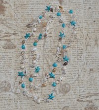 Handvirkat boho-halsband i lintråd med naturliga snäckor och syntetiska howlitepärlor i off-white och turkosa nyanser. Längd cir