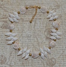 Handgjord naturinspirerad choker med äkta vita spiralformade snäckor, guldfärgade träpärlor och iögonfallande trumpetsnäckor. Ju