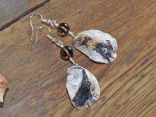 Unika handgjorda örhängen med bruna och vita ostronsnäckor från svenska västkusten och runda rökkvartspärlor. Silverpläterade kr