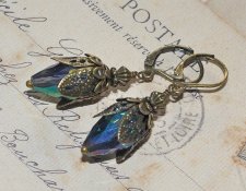 Vintageinspirerade örhängen med droppliknande iriserande kristallpärlor och antika bronsfiligrandetaljer, cirka 28 mm långa, nic